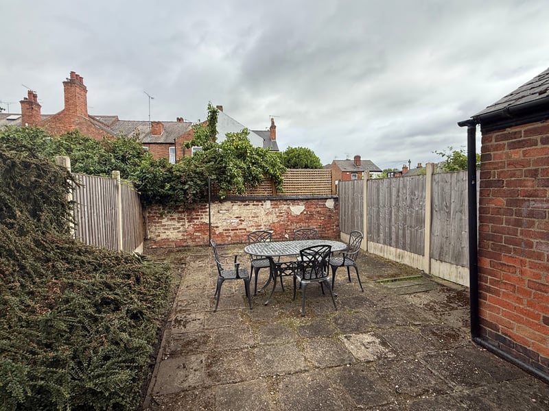 Finished paved patio with slate borders and garden furniture in Derby